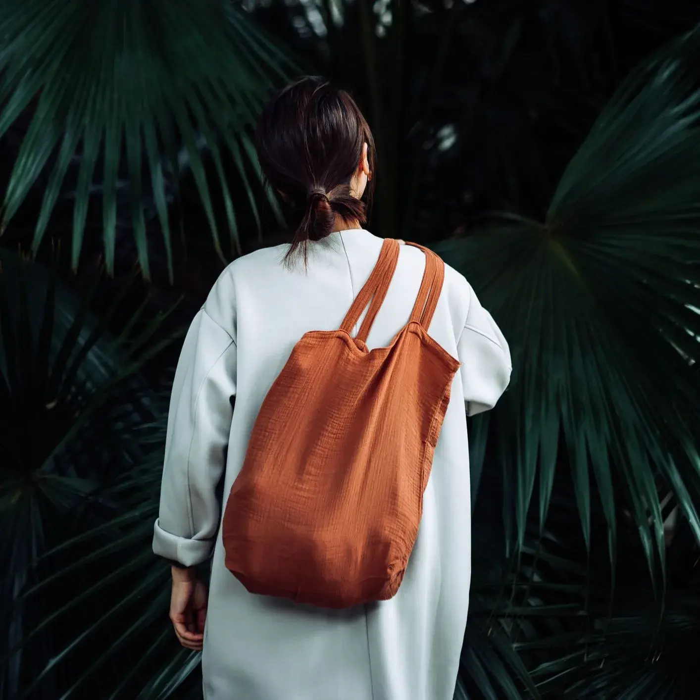 donna di spalle con una borsa di tela